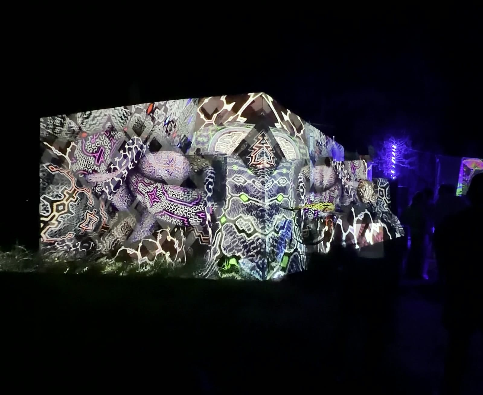 Projection mapping transforming a building at night
